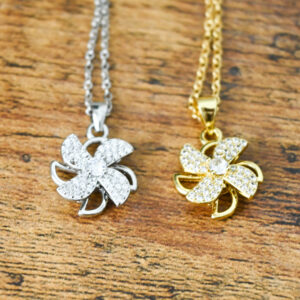 sparkly windmill spinner necklaces gold and silver side by side