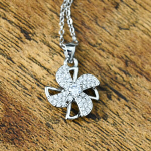 silver windmill shaped spinner covered in small sparkly rhinestones