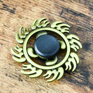 brass colored circle shape with sun flames around the circle