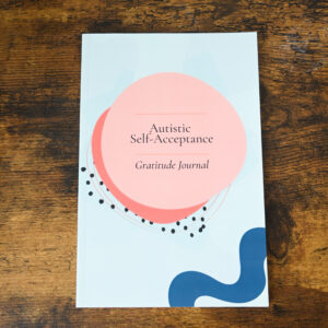 blue cover with pink circles with the text "Autistic Self-Acceptance Gratitude Journal"
