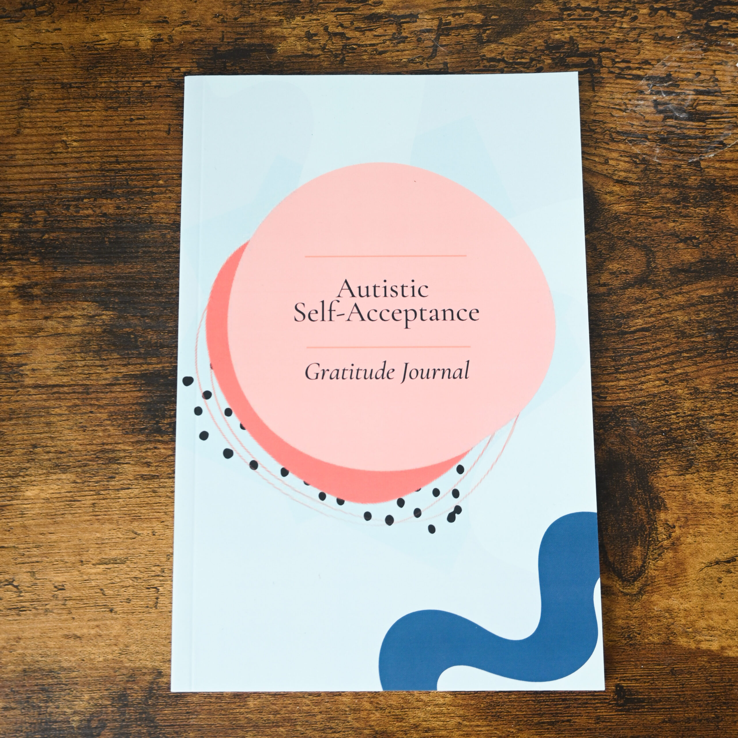 blue cover with pink circles with the text "Autistic Self-Acceptance Gratitude Journal"