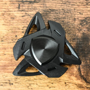 3 pointed dull edges and 2 angled blocks on the fidget spinner. The part you hold on to is a triangle shape. The texture is a made up of tiny engraved lines to give it a unique appearance.