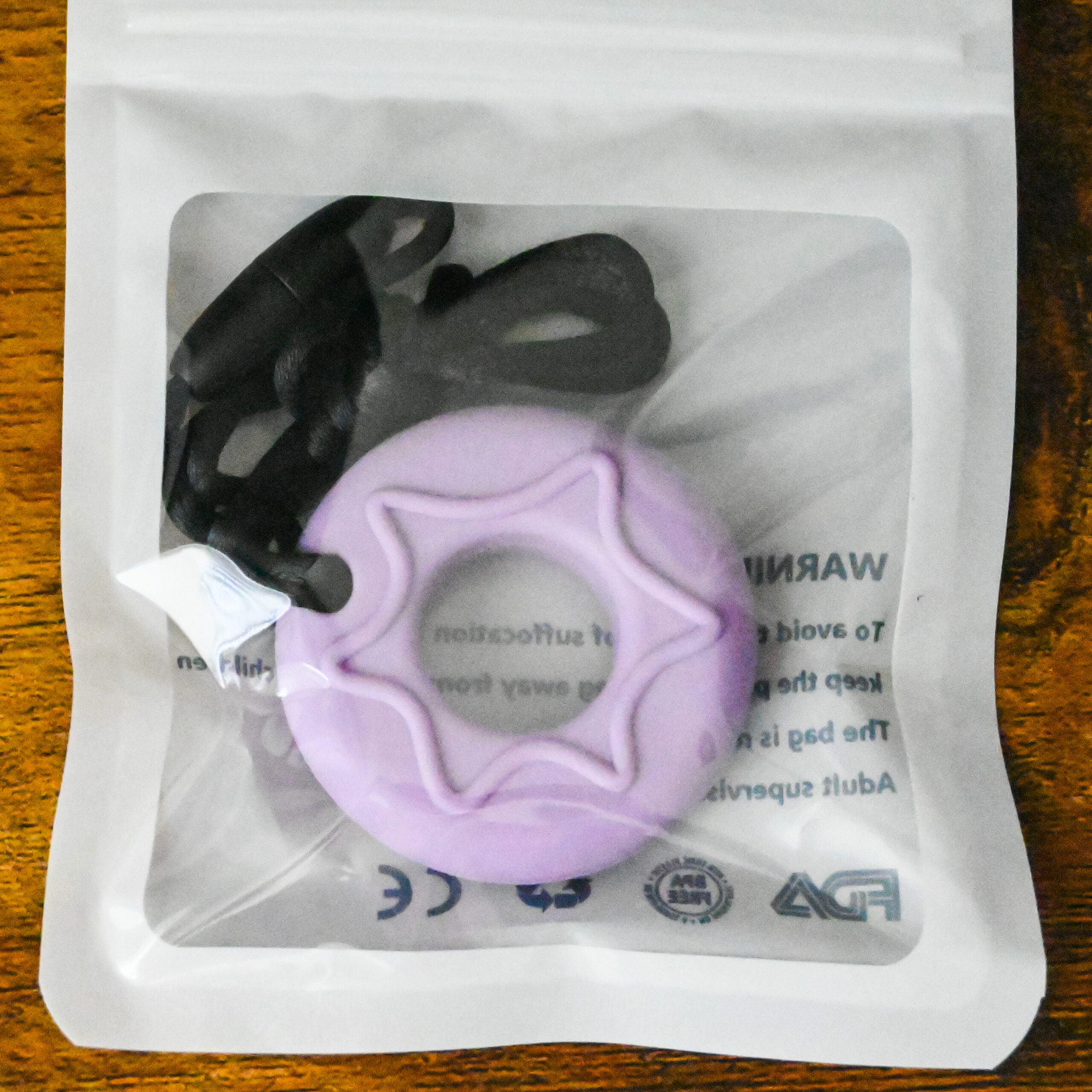 purple donut chew pendant inside the bag packaging