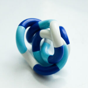 dark blue, light blue, white twisty fidget in a twisted position like a modern art sculpture and a vintage film feel
