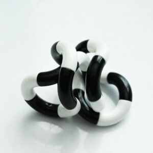 black and white twisty fidget toy in a twisty position