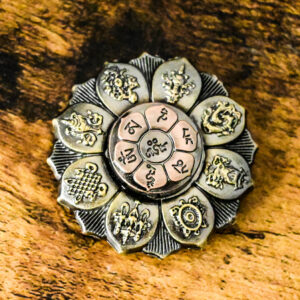 intricately designed bronze lotus flower with symbols on each leaf and a pale purple metal center engraved with symbols