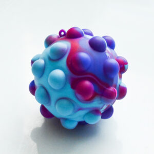 light blue, dark pink, dark blue tie dye pattern. The bubble wrap fidget has bubbles sticking out around the ball giving a vintage modern art sculpture appearance taken with a film camera