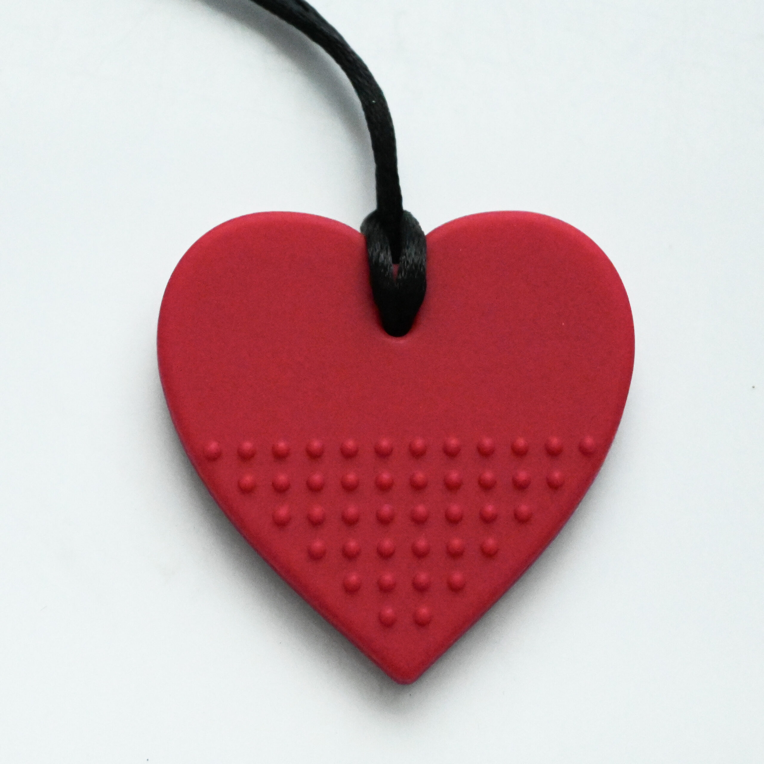 a rich lipstick shade of dark magenta heart chew pendant