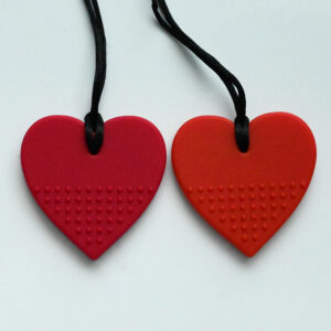 the magenta and red color heart chew necklaces side by side