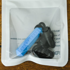 blue mini prism chew necklace with wavy lines for texture inside the bag packaging