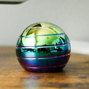 shiny rainbow gradient metal desk spinner on a wood table