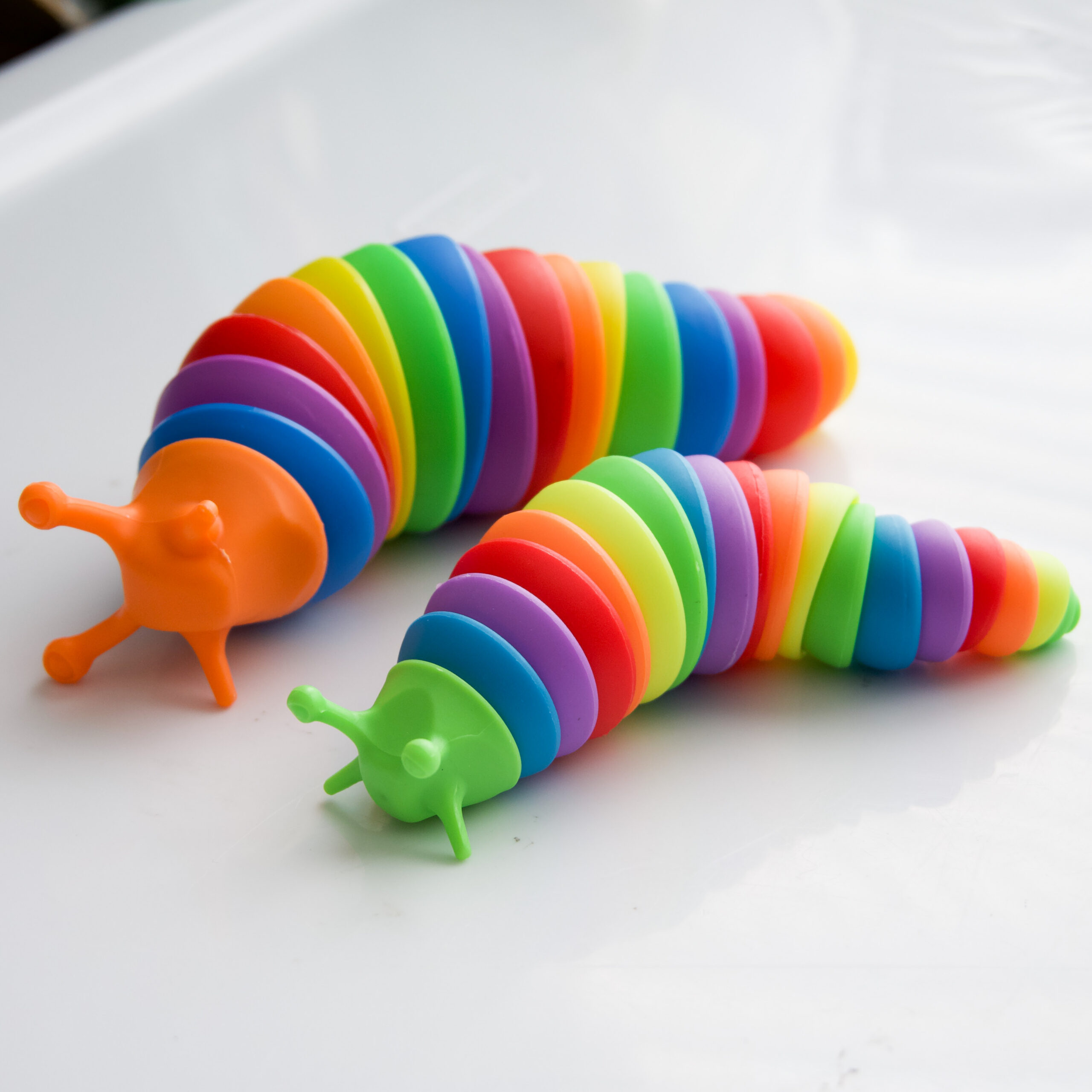 the bigger slug fidget next to the mini slug fidget to show a size comparison. The Mini is the same length as the big one, but everything else is smaller.