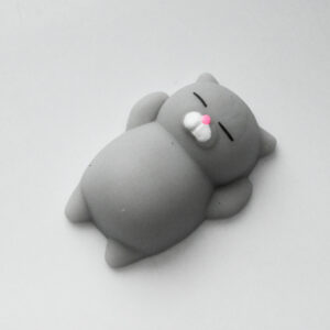 soft grey cat mini squishy on light grey surface creating a film art style effect