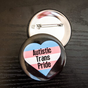 black background with the trans flag in a heart shape and "Autistic Trans Pride" inside the heart