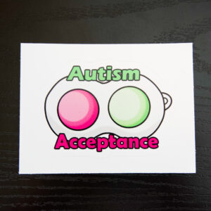 bubble wrap keychain with 2 pop bubbles, 1 pink 1 green. The text "Autism" is in green, and "Acceptance" is in pink.