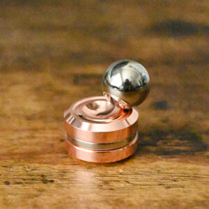 magnetic rose gold base laying flat with the magnetic silver ball sitting on top of the edges.