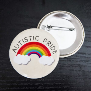 beige background with a rainbow graphic that has clouds at both ends. The text "Autistic Pride" is curved around the rainbow.