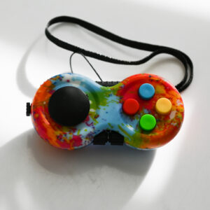 paint splatter print fidget with multicolored buttons, black joystick, black gears on the sides