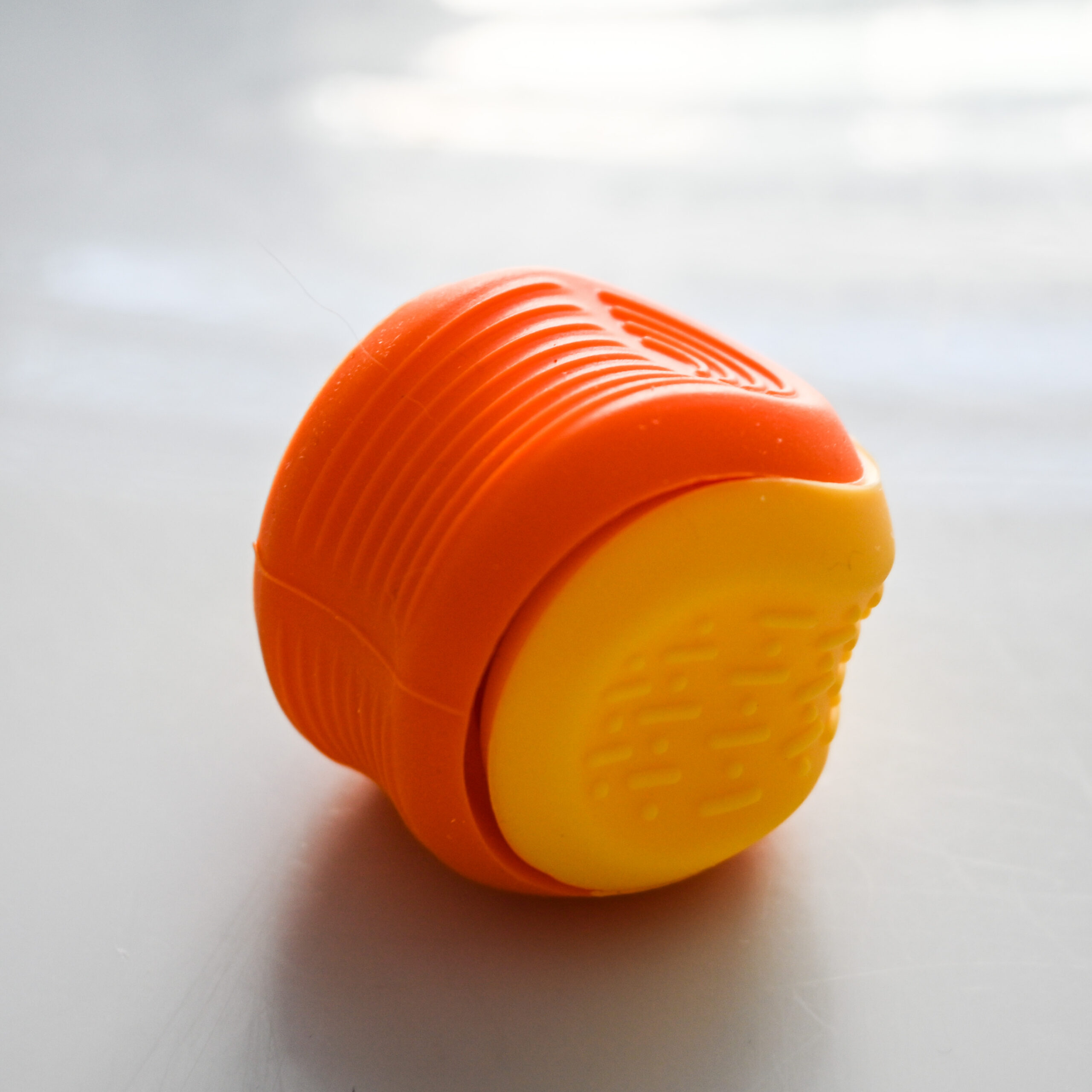 worry stone ball with 2 textures. 1 raised lines and 1 evenly spaced lines and dots texture