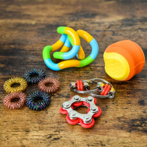 Acupressure rings, twisty fidget toy, worry stone ball, and bike chain fidget set.